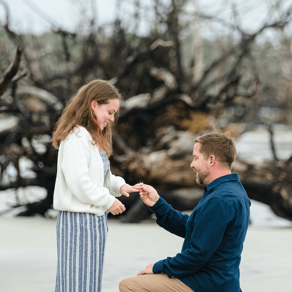 Couple standing by large tree